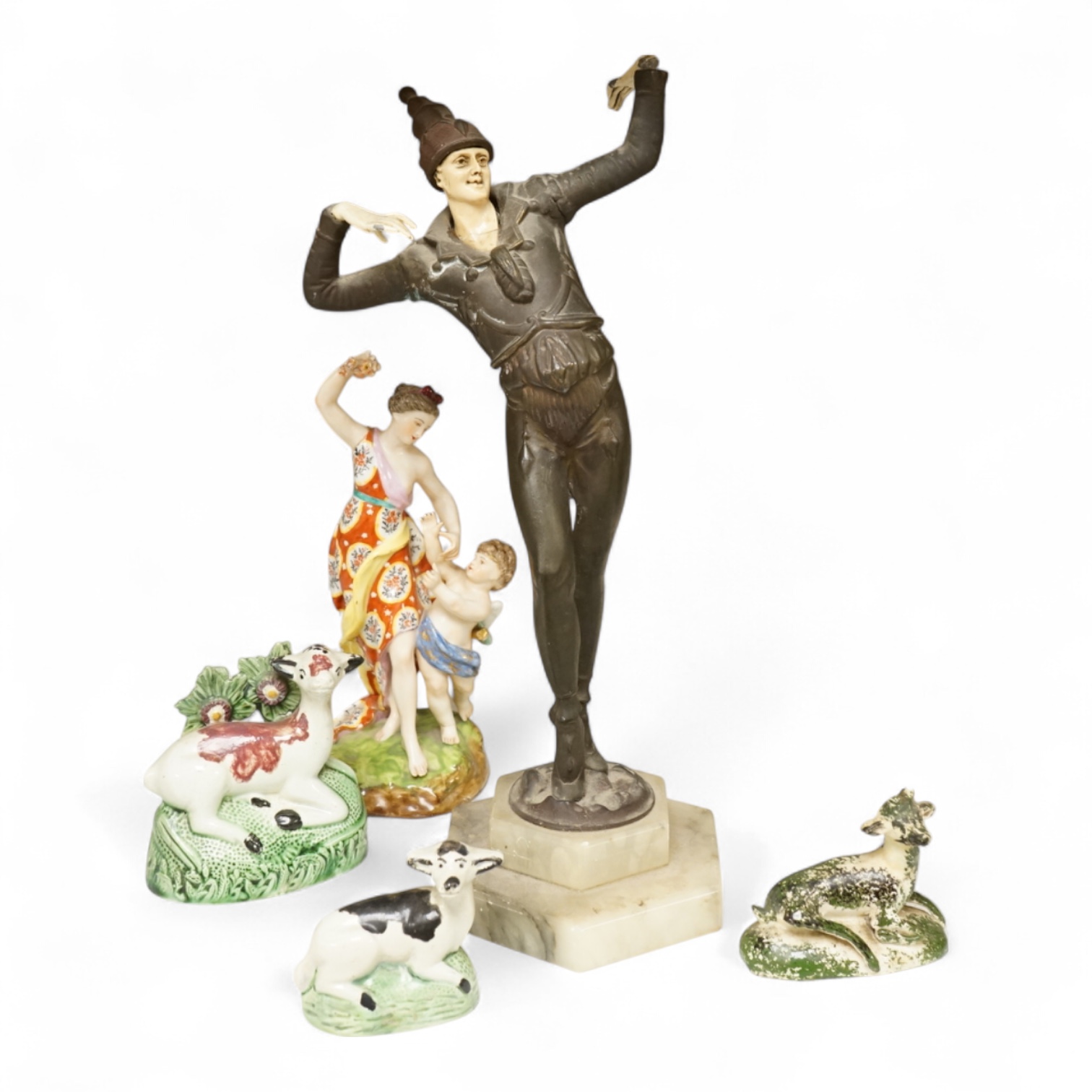 An Art Deco resin and patinated spelter model of a dancer on onyx base, two late 18th century Staffordshire coloured creamware recumbent cows and a spongeware deer, a WWI commemorative teapot with ‘For Right and Freedom’